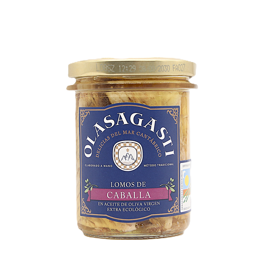 Olasagasti glass jar of mackerel fillets in organic extra virgin olive oil, featuring a dark blue label with a purple banner and aged gold vintage details, closed packaging showing the fish fillets through the glass