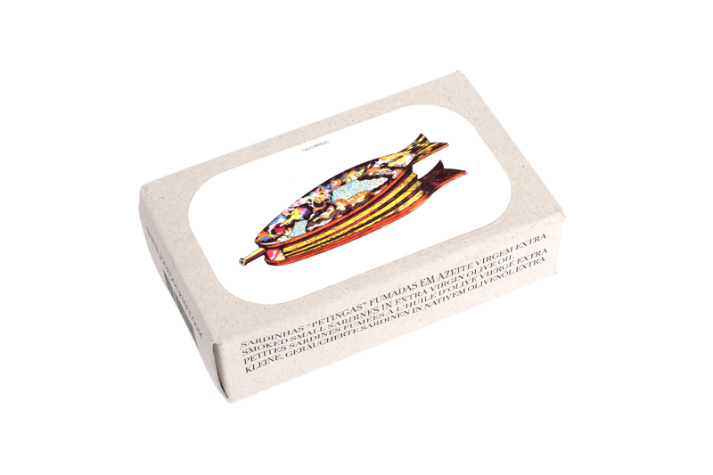 José Gourmet Smoked Small Sardines (Petingas) in Extra Virgin Olive Oil. The artistic packaging features a colorful, surrealist illustration of a fish by artist Tiago Manuel. Minimalist cardboard box with multilingual descriptions, representing premium Portuguese tinned seafood and contemporary art fusion.