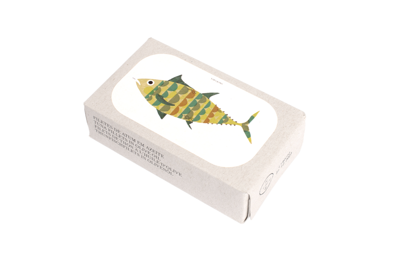 José Gourmet Tuna Fillets in Olive Oil (Filetes de Atum em Azeite). The artisanal cardboard packaging showcases a vibrant, geometric illustration of a tuna fish by artist Yara Kono. This premium Portuguese canned seafood is presented in a modern, multilingual box, combining high-quality fillets with contemporary graphic design.