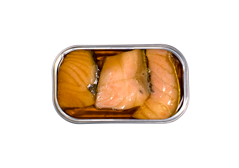 Inside an open tin of José Gourmet Smoked Salmon in Extra Virgin Olive Oil. Three thick, succulent pink salmon fillets are perfectly preserved in golden oil. The image showcases the meaty texture and vibrant natural color of the fish, highlighting the premium quality of this Portuguese artisanal canned seafood.