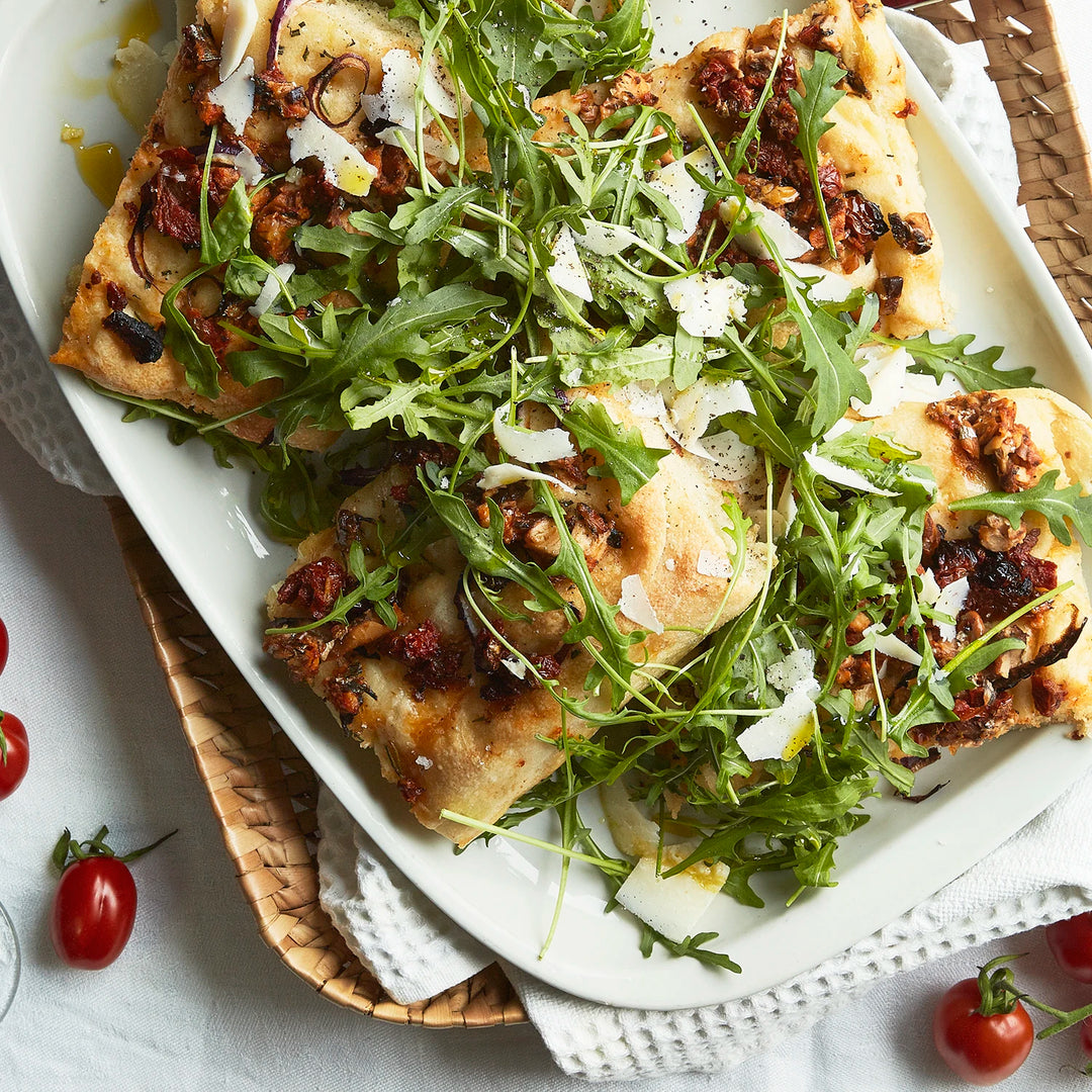 Focaccia made with Sardines - in Tomato Sauce, decorated with arugula